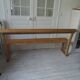 Church bench, bed end in pitch pine with light oak wax finish.