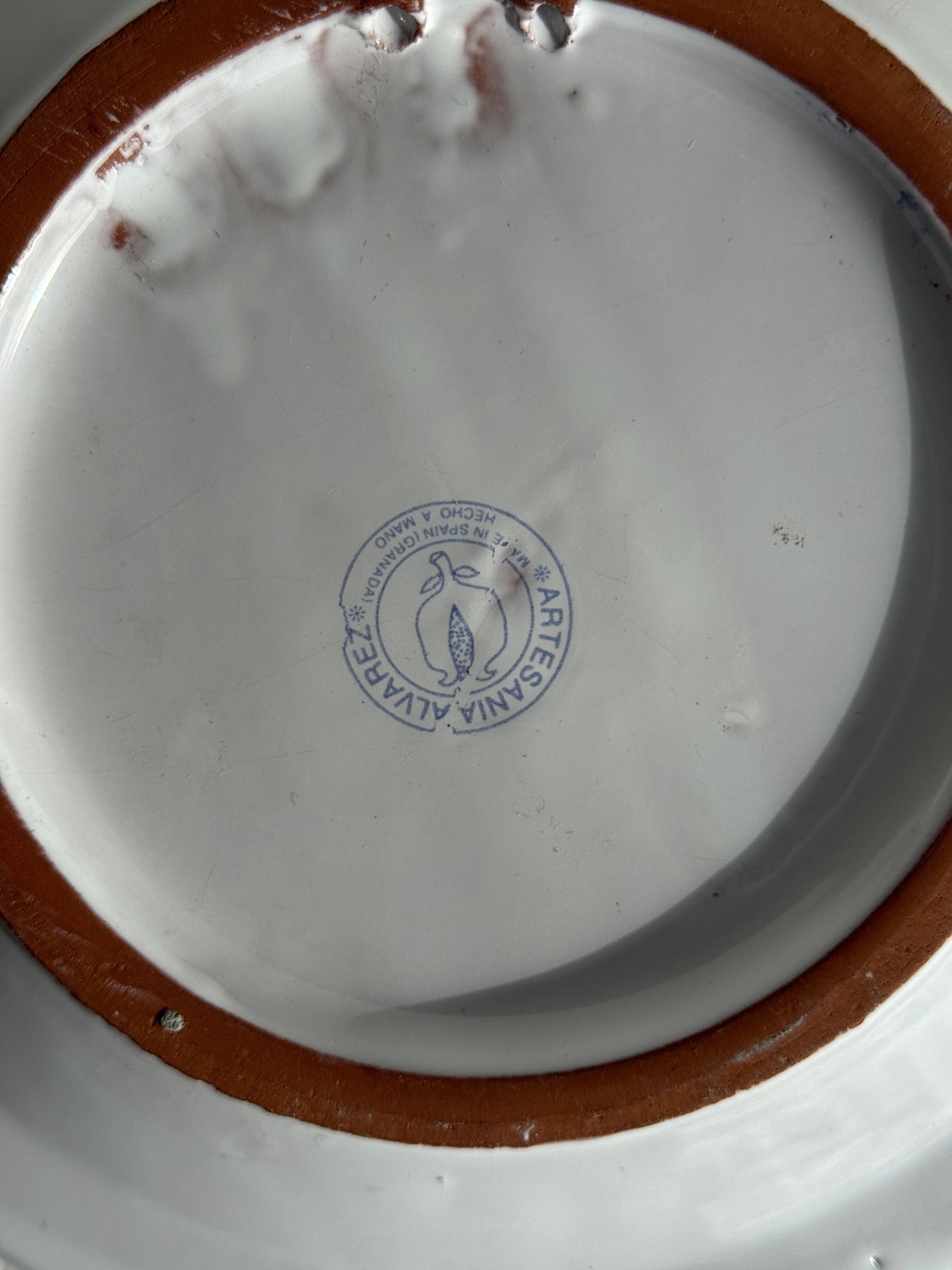 Artesania Alvarez Spanish plate in terracotta with blue plant motif.