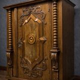 Ornamental piece of solid wood furniture, richly carved, dating from the 17th century.