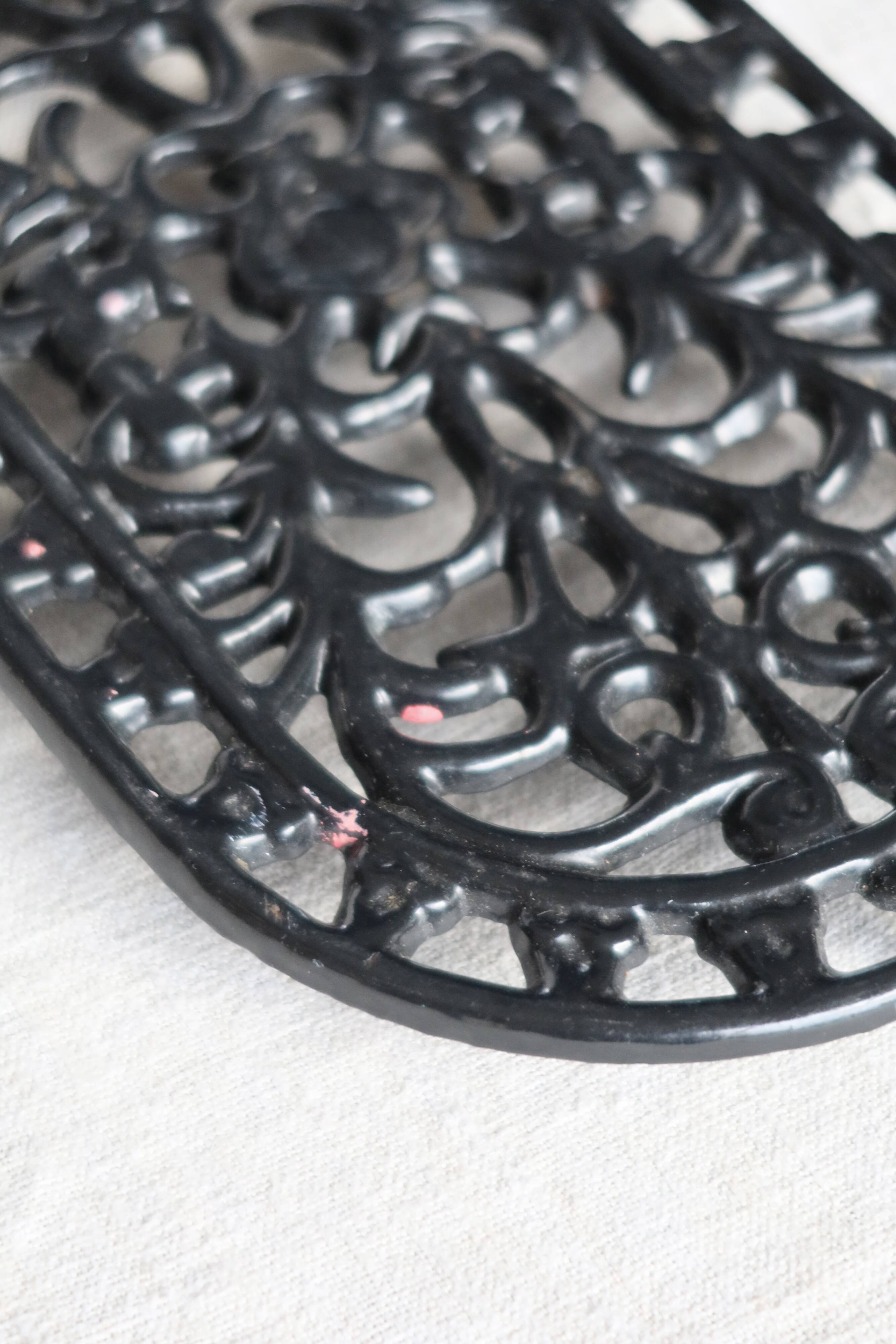 Vintage black cast iron oval trivet - Openwork design