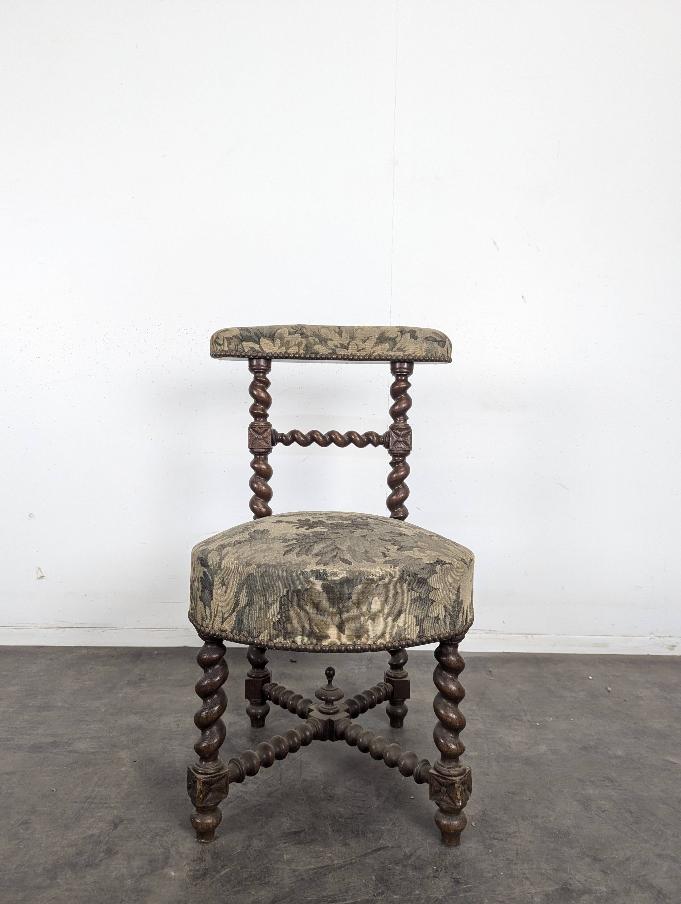 Napoleon III smoking chair in twisted blackened wood with foliage upholstery.