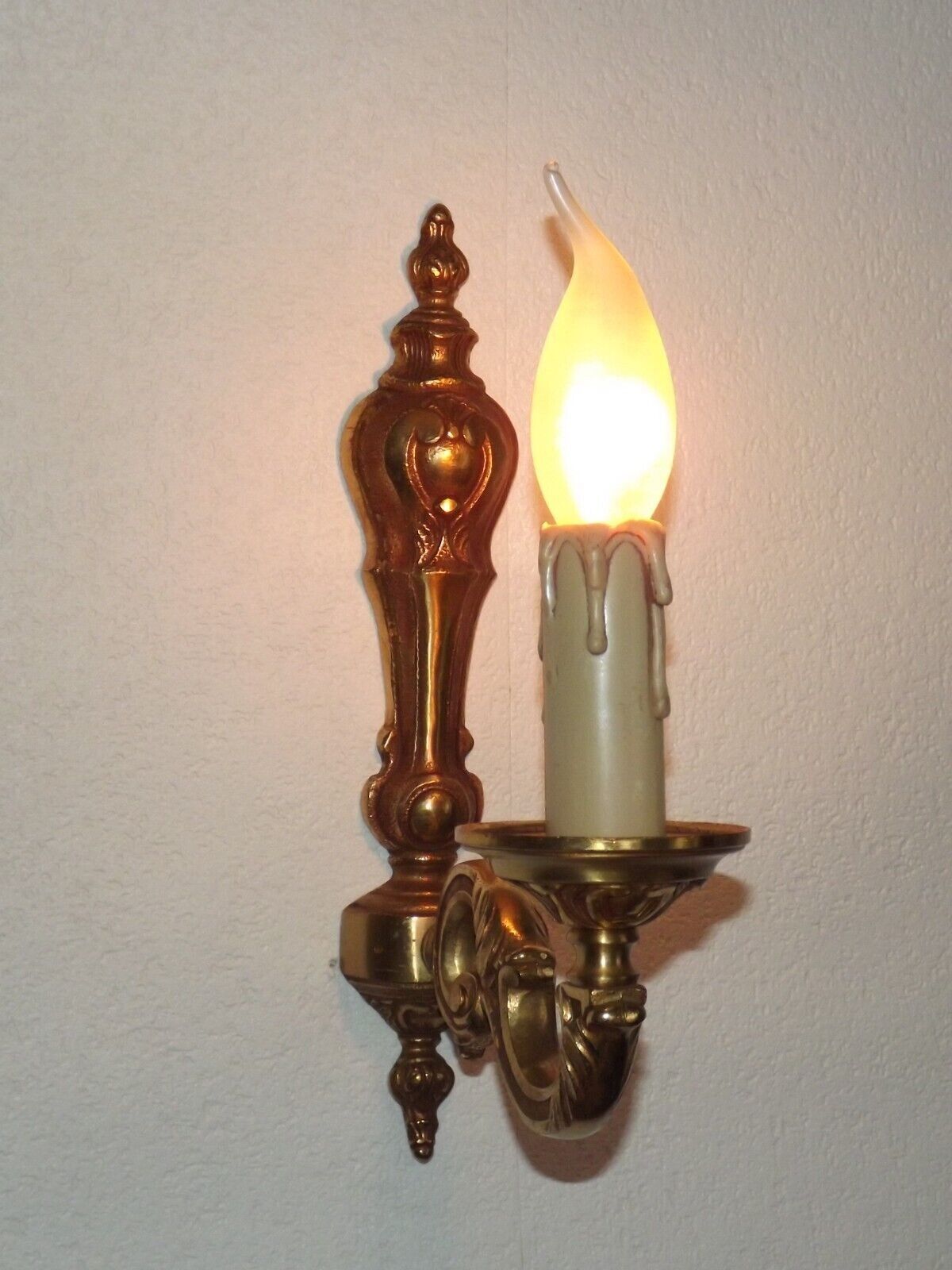 Simple wall sconce in classic Empire style in vintage French bronze.