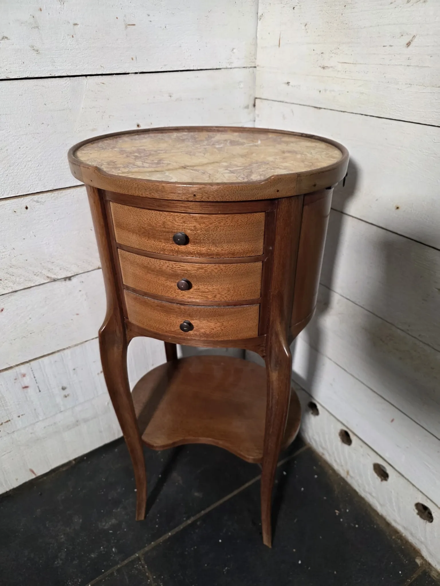 Oval bedside table in Louis XV style made of mahogany.