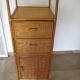Storage column, wooden bookshelf and woven rattan.