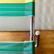 Vintage folding beach chair in chrome metal and woven plastic