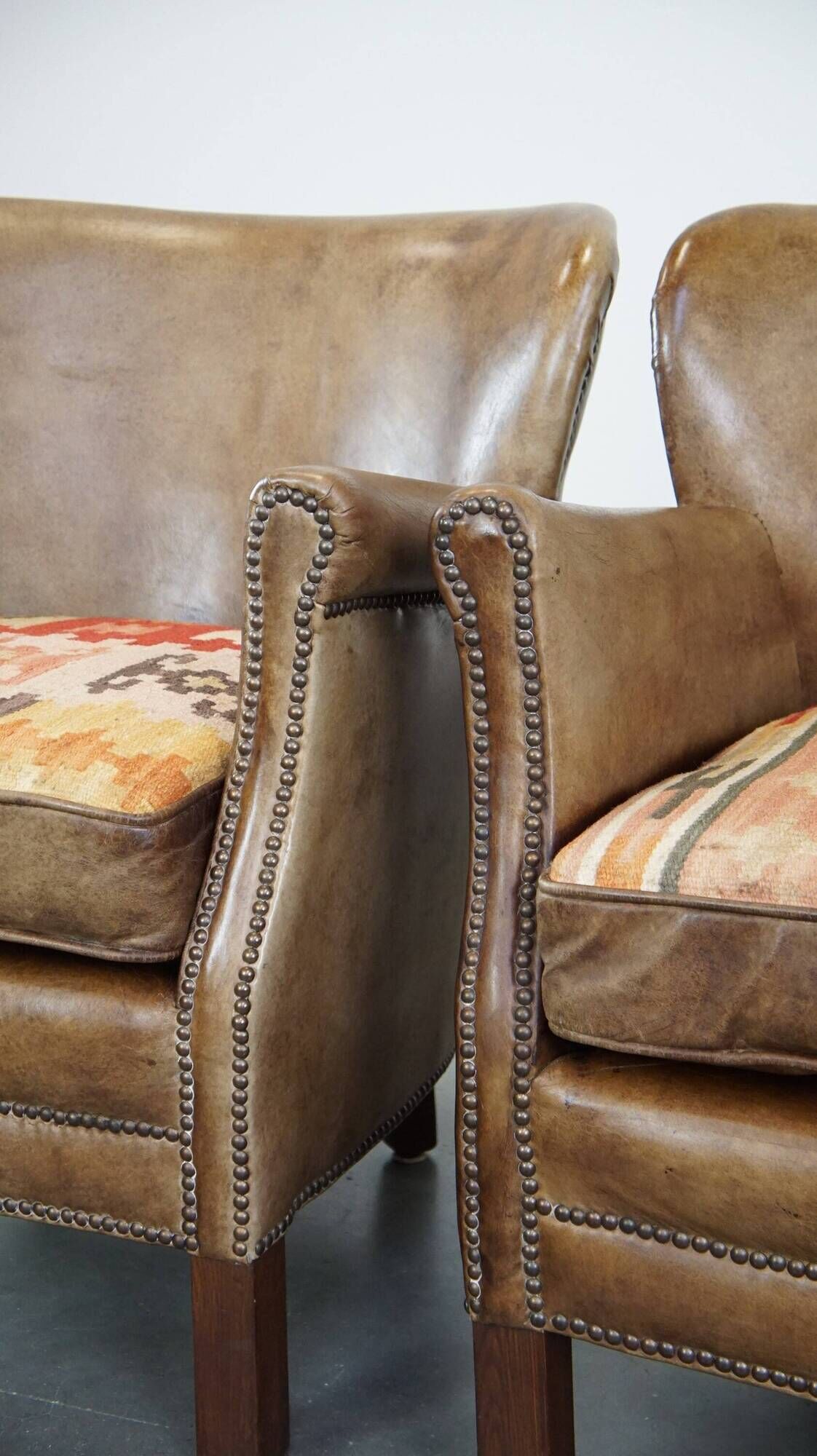 Set of 2 nice, subtle cowhide armchairs with reversible Kelim seat cushions