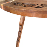 Circular tripod coffee table in carved wood