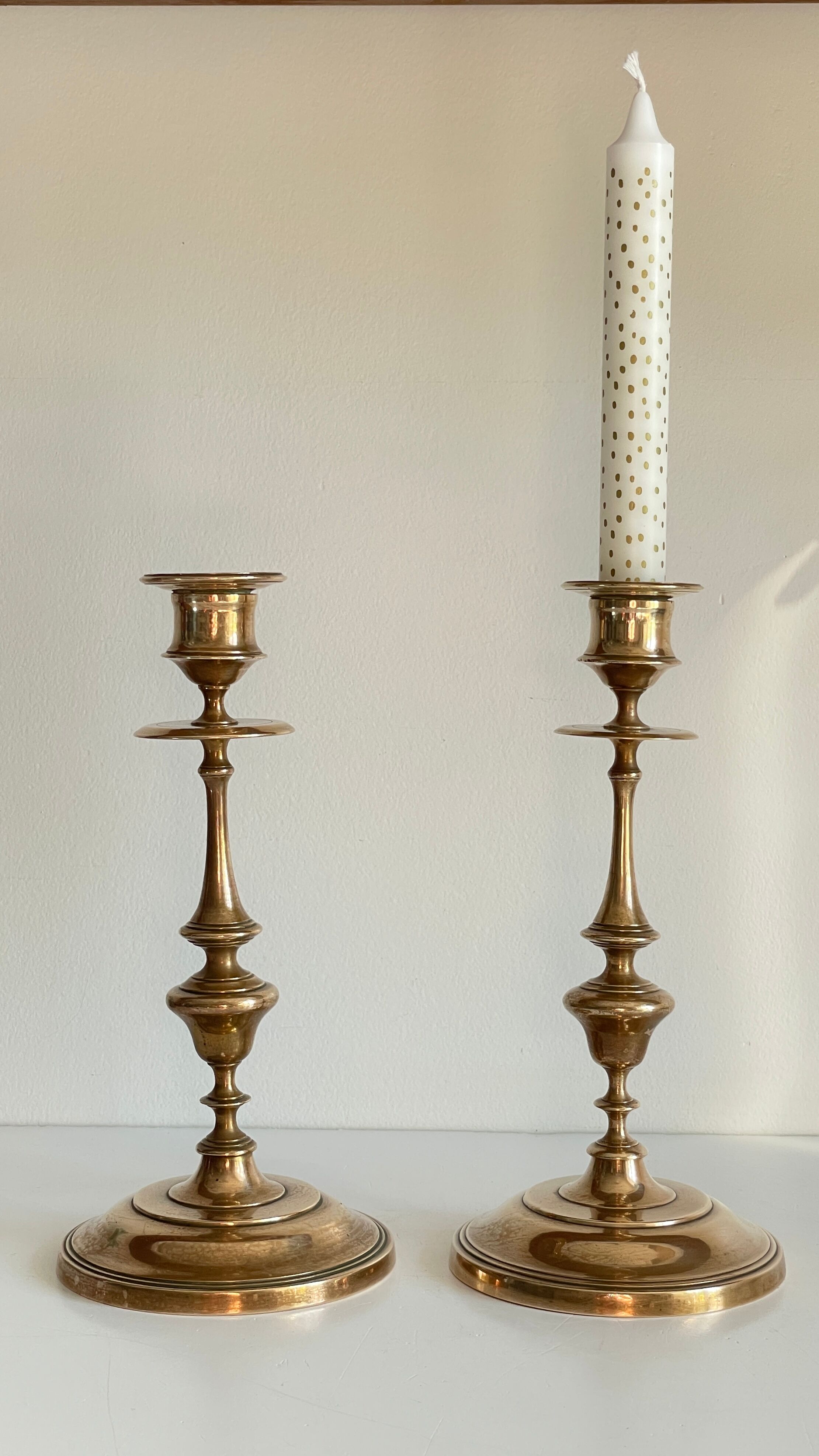 Pair of antique candle holders in solid brass