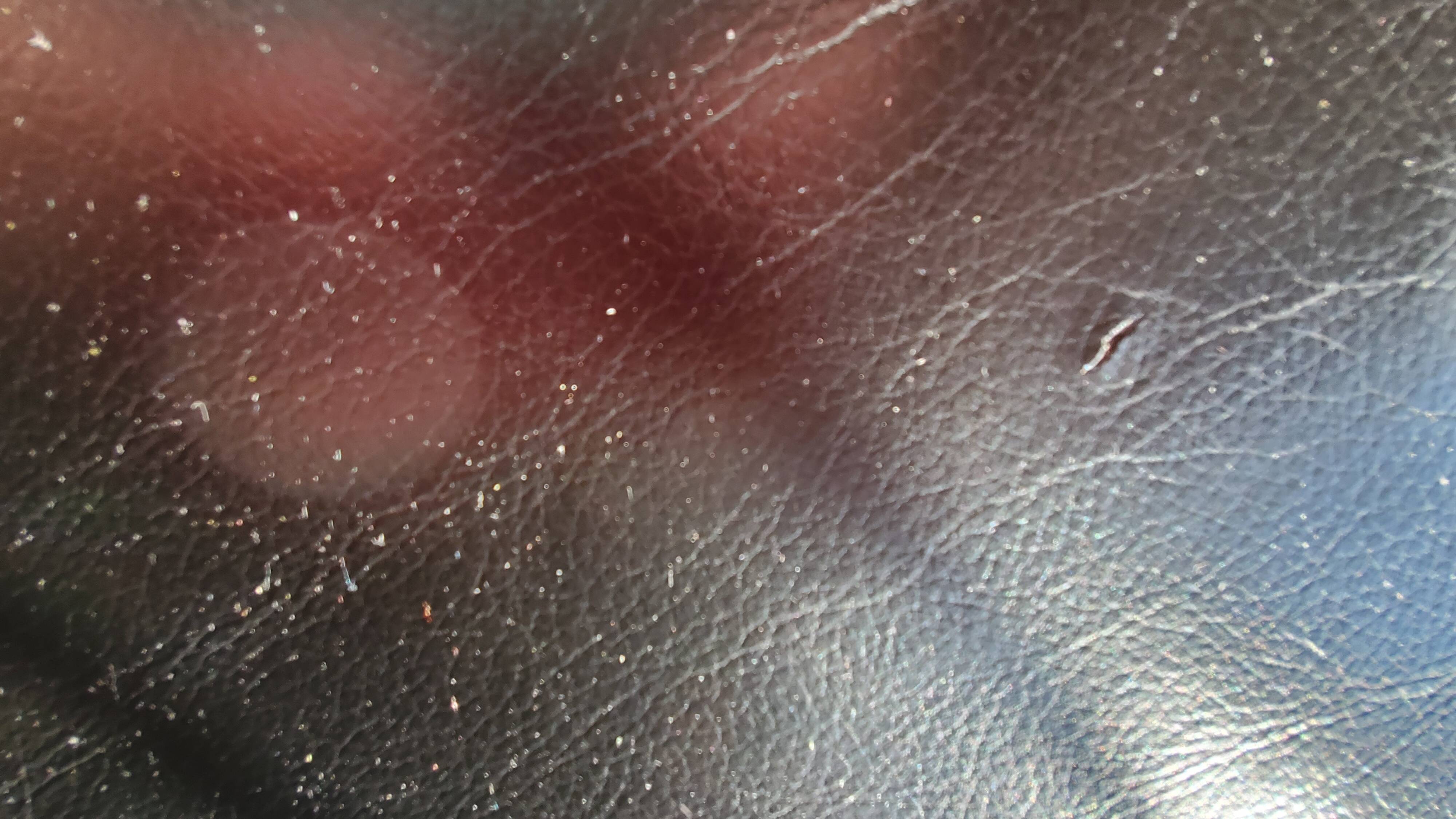 Black leather three-seater sofa