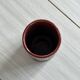 Small antique roller vase in red enamelled ceramic