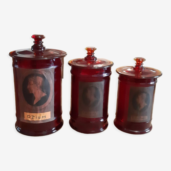 3 red glass medicine jars