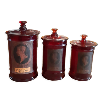 3 red glass medicine jars