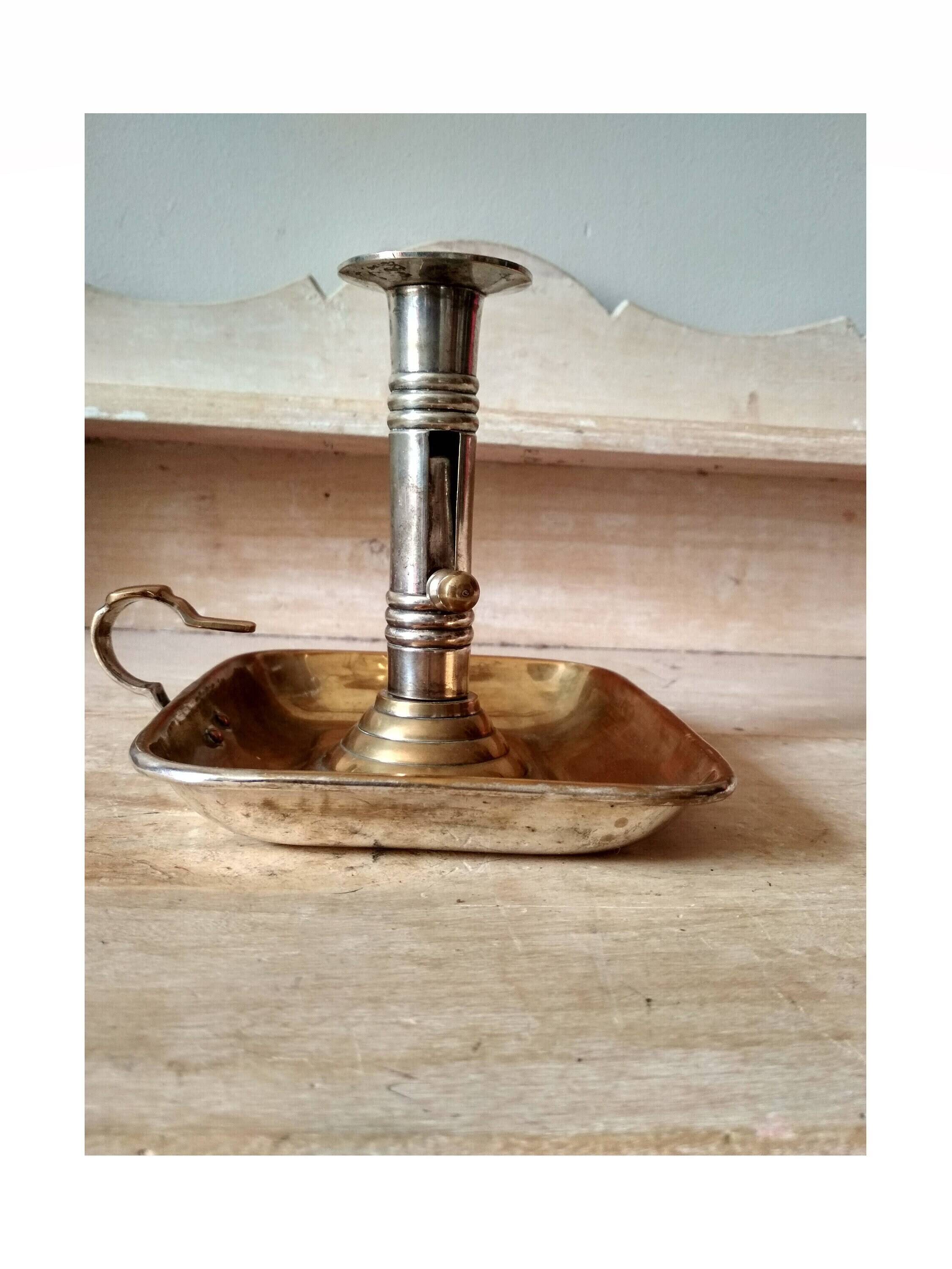 Antique metal and brass hand candle holder on rectangular base