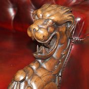 Victorian Chesterfield leather sofa with carved lion heads.