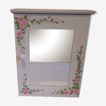 White mirrored toilet cabinet with floral pattern