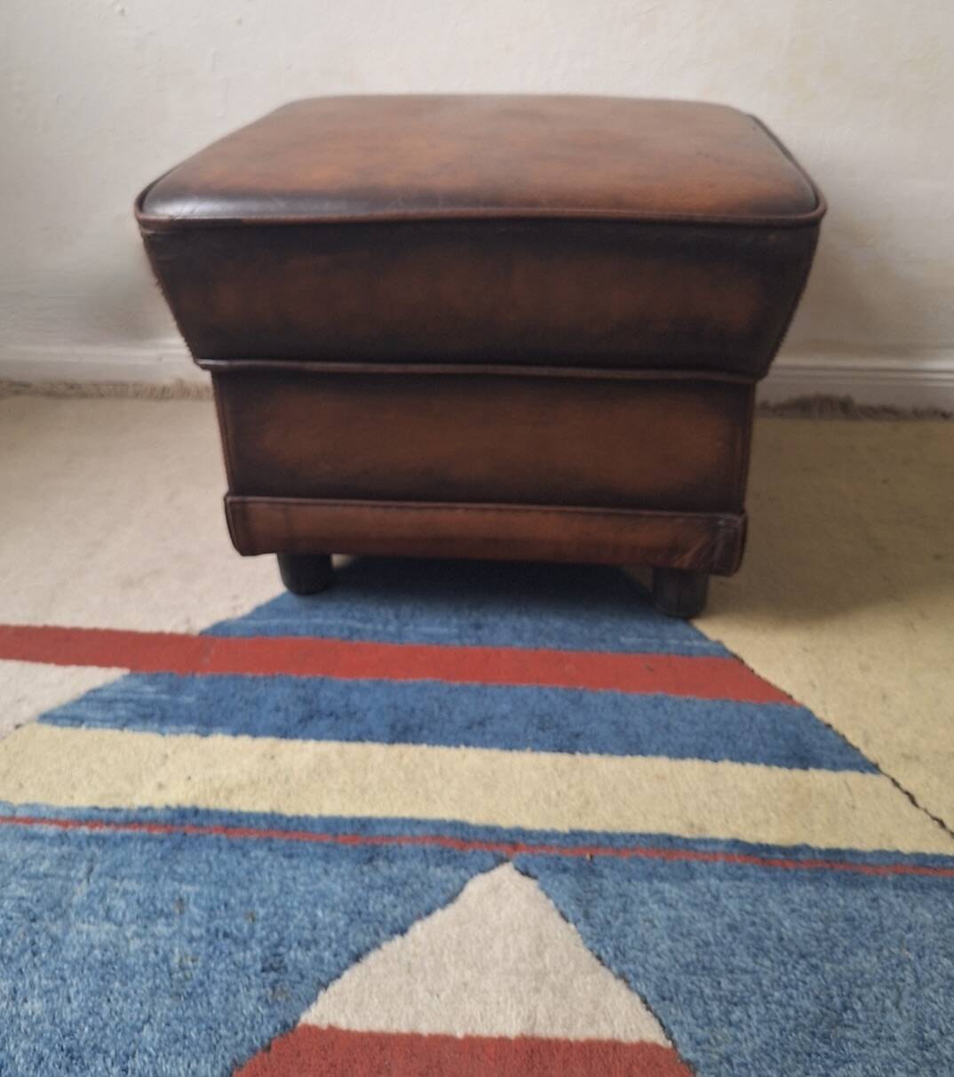Vintage ottoman / pouffe in chestnut brown leather