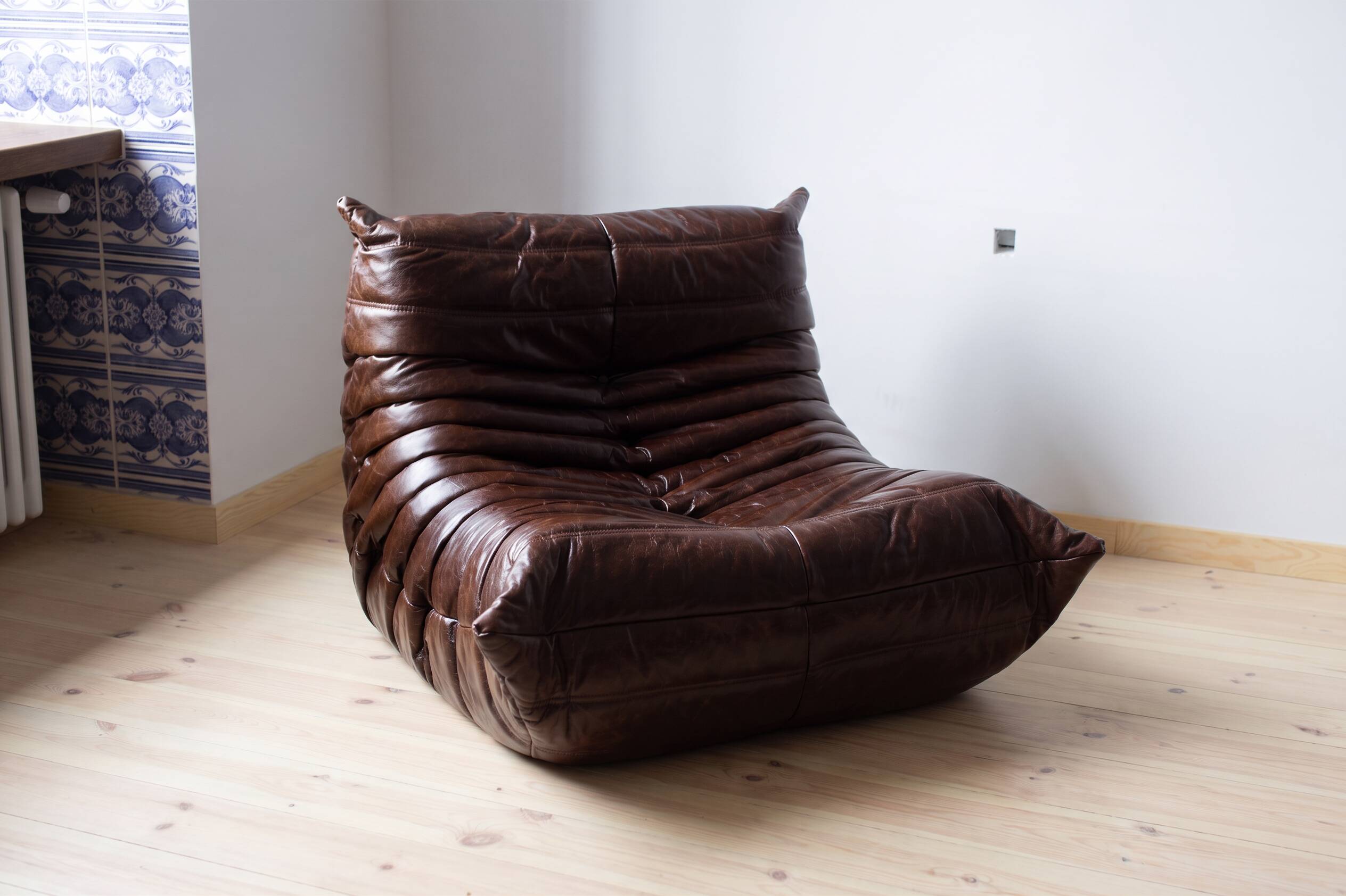 Togo armchair in dark brown shiny leather