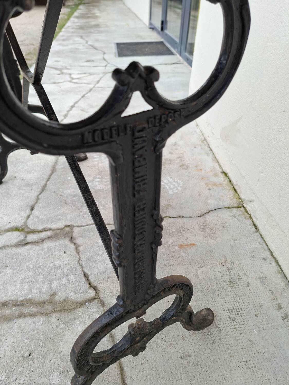 Solid oak bistro table with a cast iron base, signed.