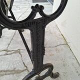 Solid oak bistro table with a cast iron base, signed.