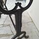 Solid oak bistro table with a cast iron base, signed.