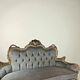 A soft light blue and silver tufted beech wood sofa in Louis style.