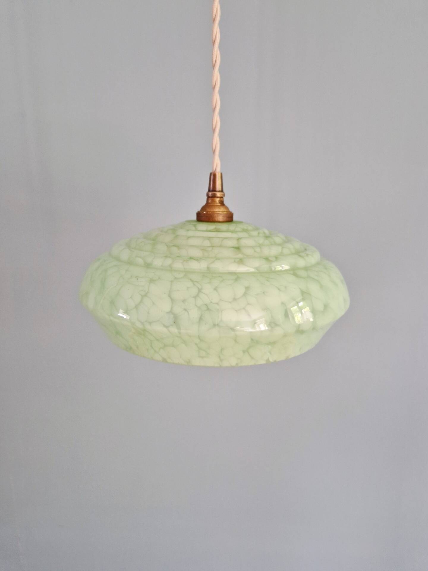 Pair of Art Deco light fixtures in light green speckled glass, 1930s.