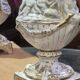 Italian coffee table with glass top, wooden base, and porcelain legs