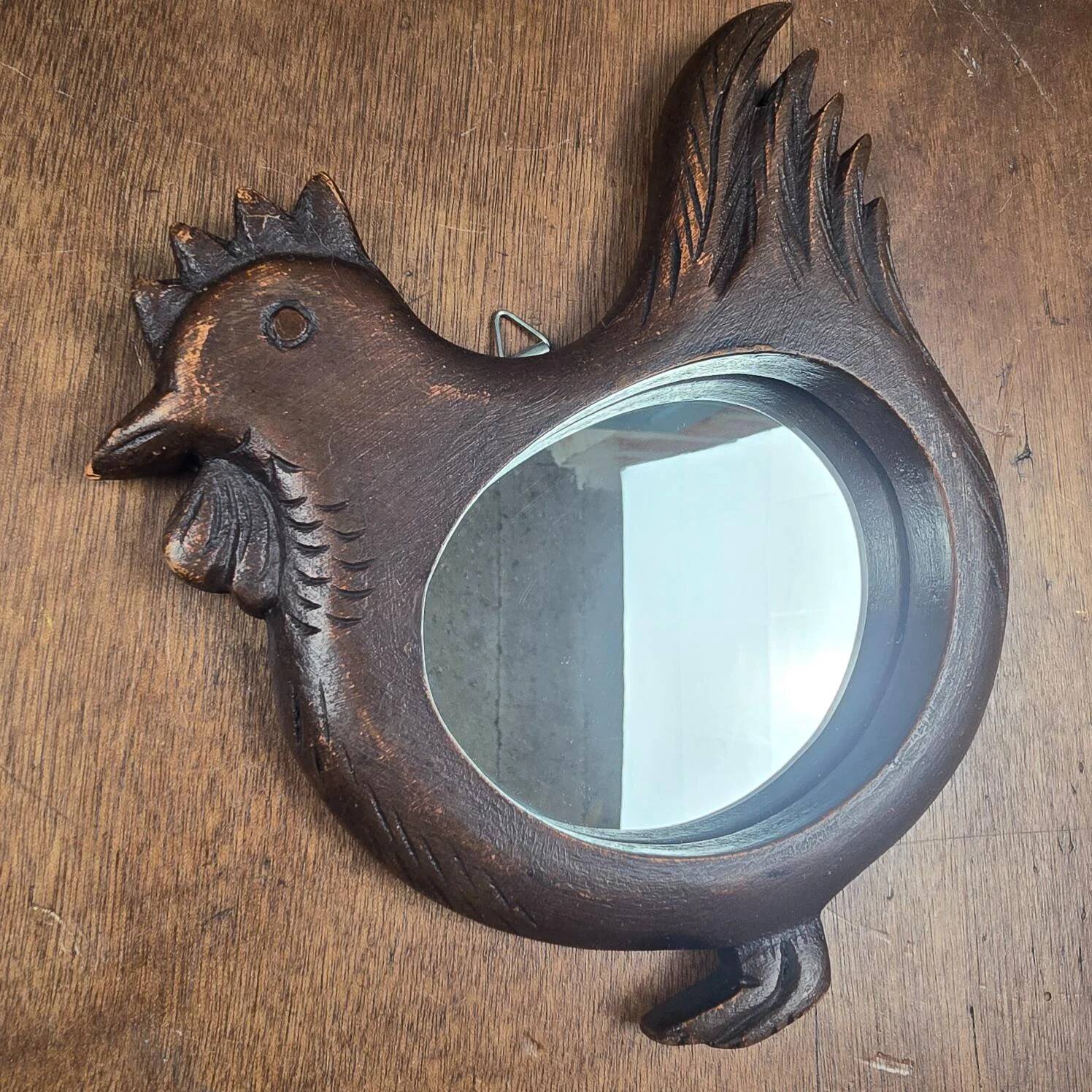 Vintage carved wooden chicken-shaped wall mirror.