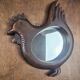 Vintage carved wooden chicken-shaped wall mirror.