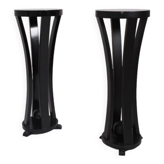 Pair of high round black lacquered wooden pedestal tables, 1960s.