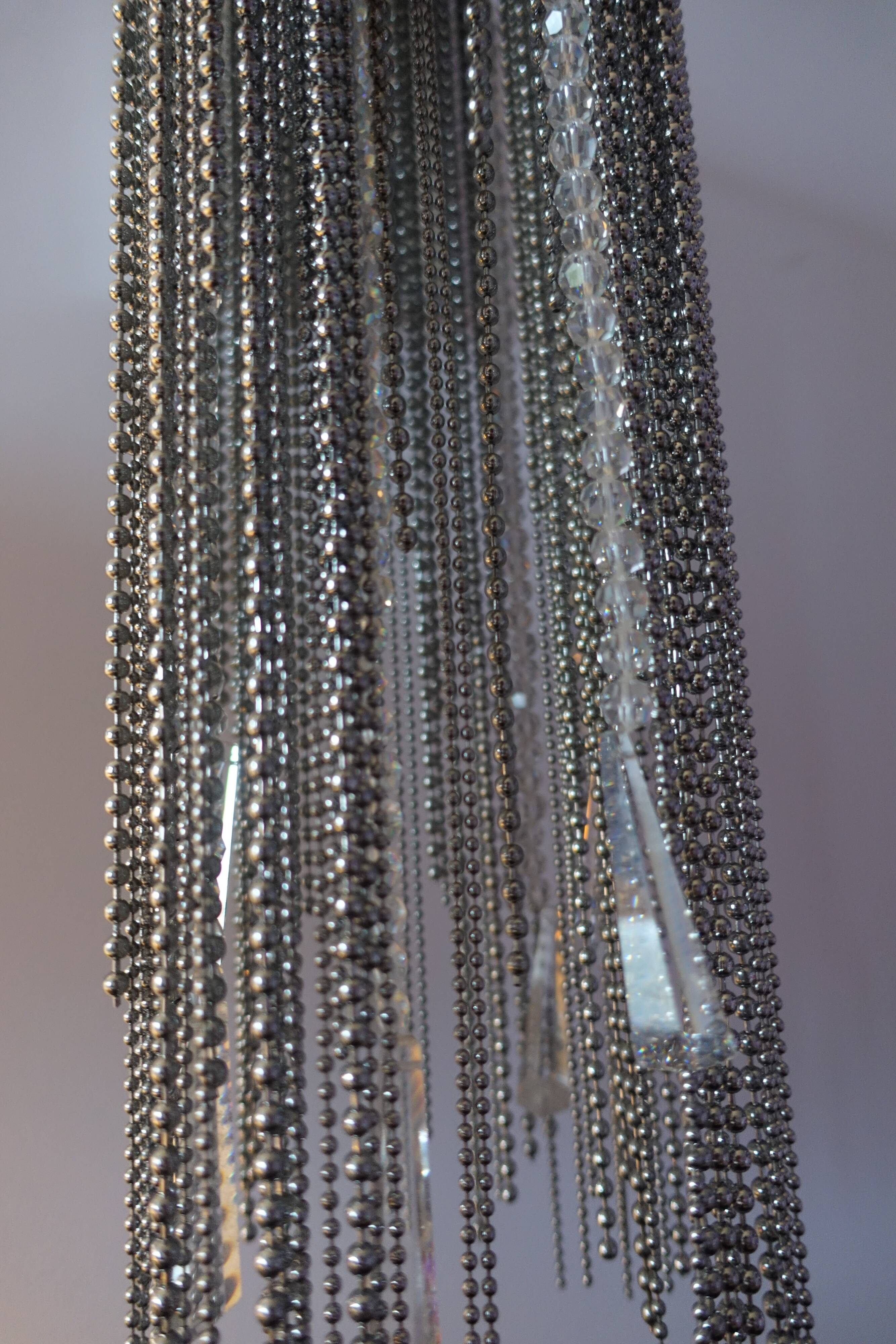 Swarovski wall lamp in silver-plated metal with crystal pendants.
