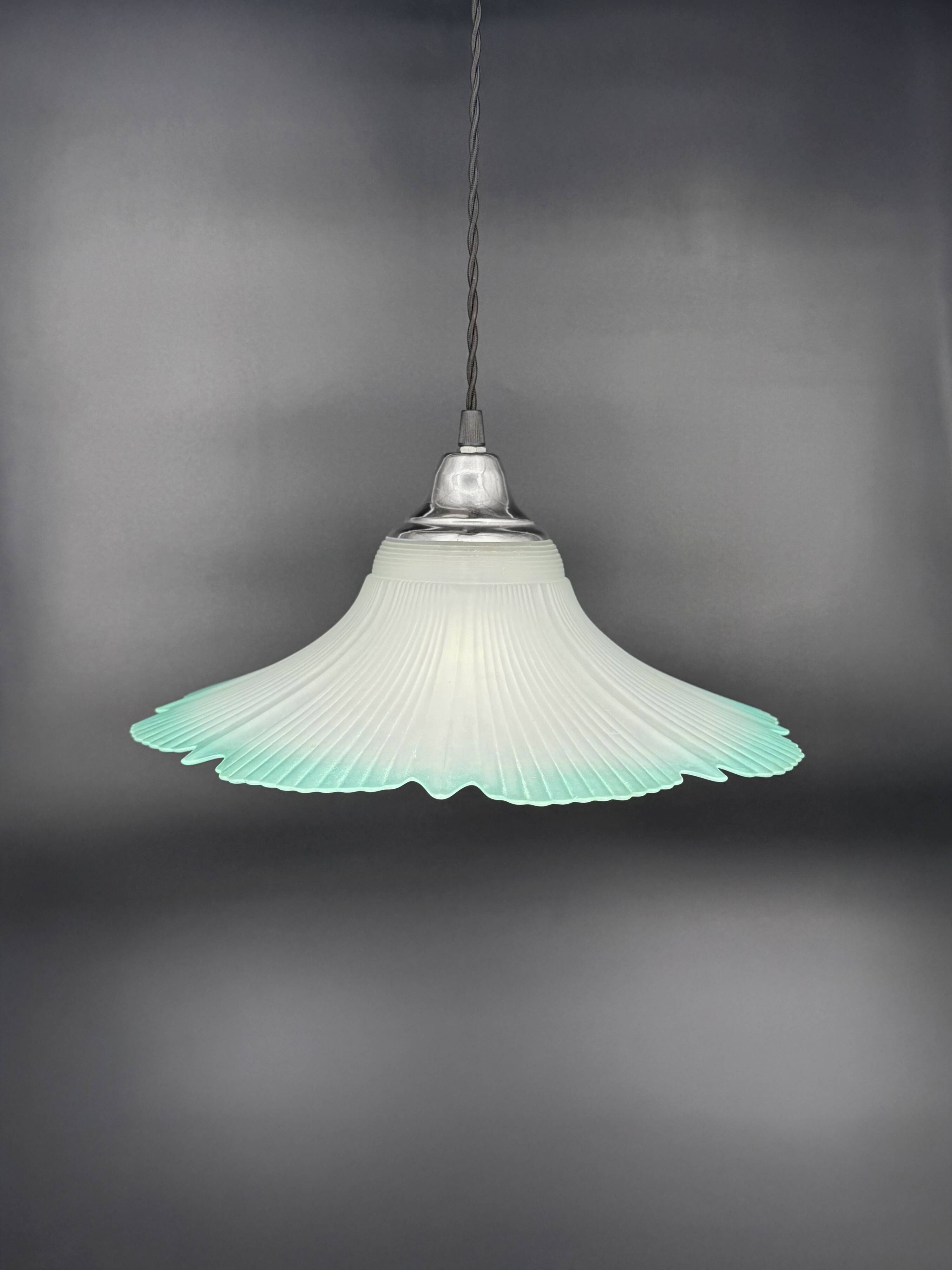 Frosted glass flower pendant with a water green edge.