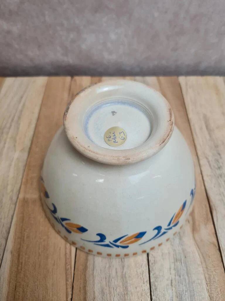Old ironstone bowl with vintage blue and ochre decoration.