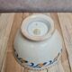 Old ironstone bowl with vintage blue and ochre decoration.