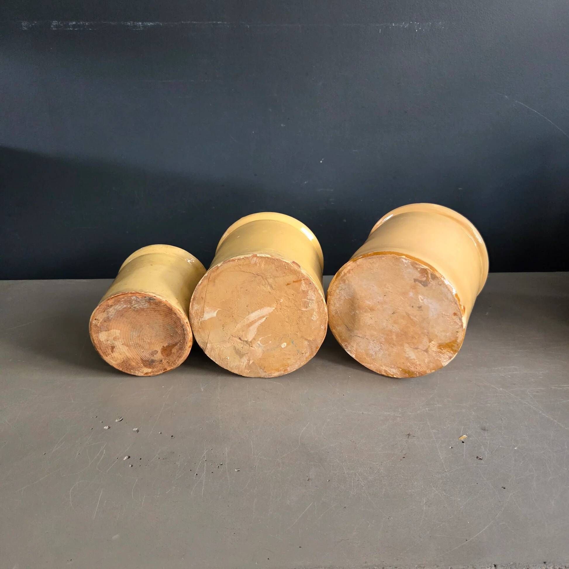Trio of ancient pots in yellow glazed terracotta.