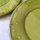6 olive green plates with dotted relief, workshop ceramic style