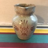 Old gray pitcher with black drawings and vintage stamped handle