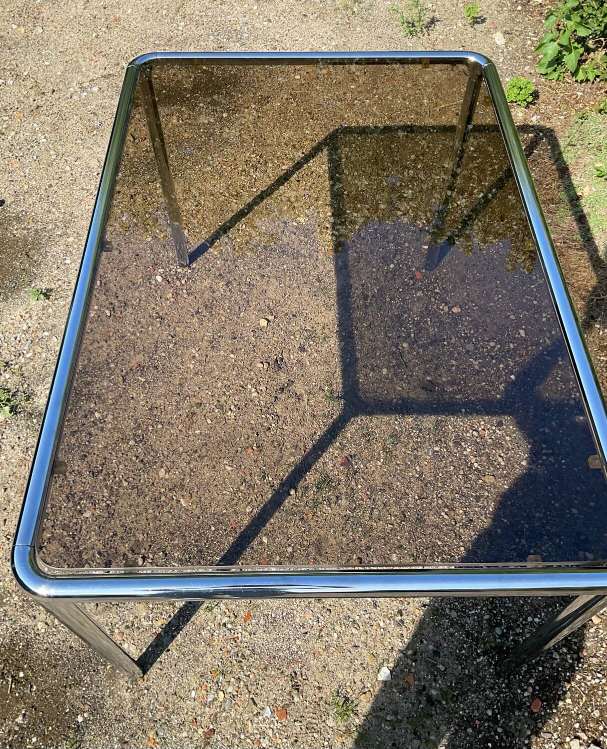 70s dining table in tubular chrome metal and smoked glass