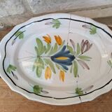 Old oval dish with floral motif called black bottom with staples