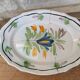 Old oval dish with floral motif called black bottom with staples