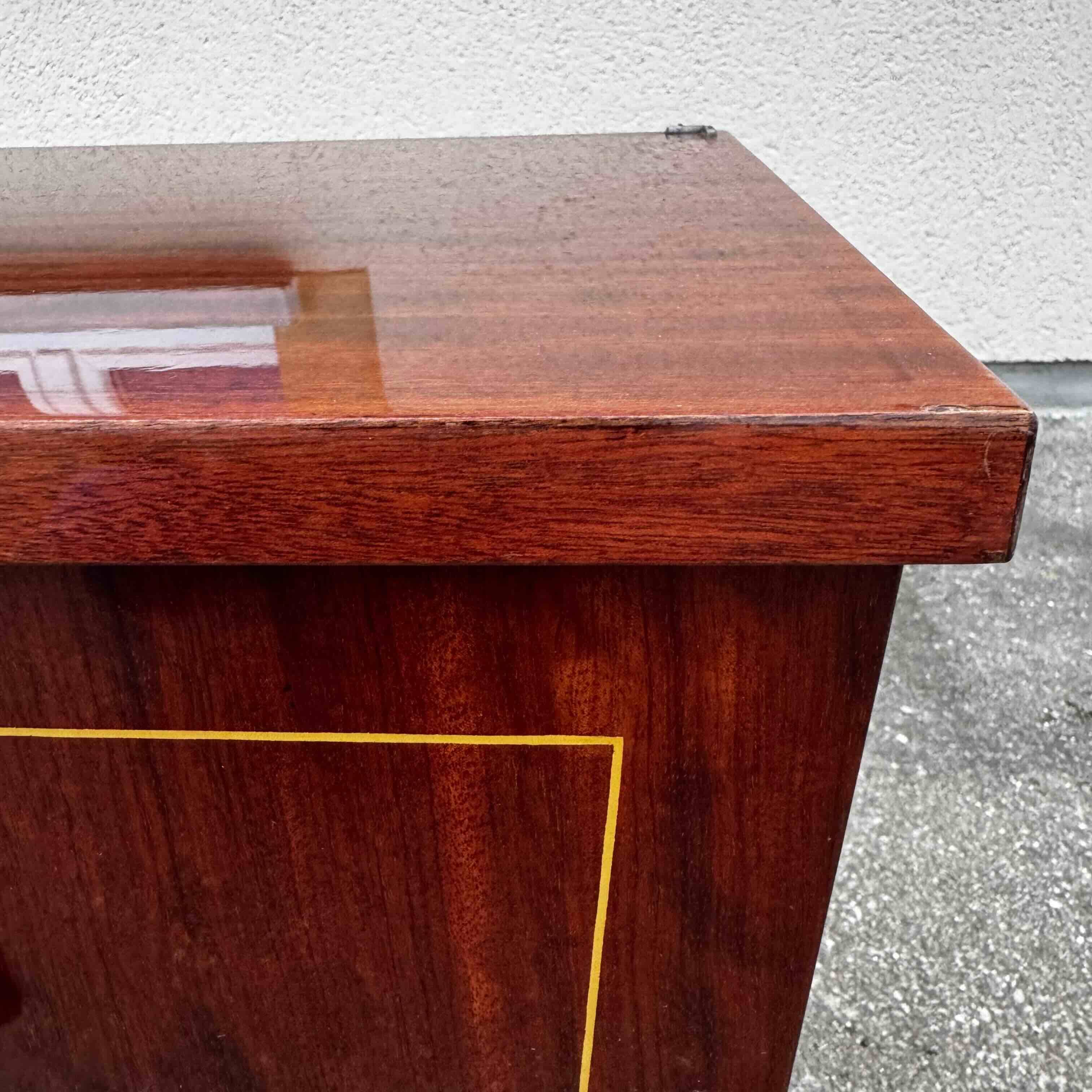 1950s bedside table in varnished wood veneer and brass.