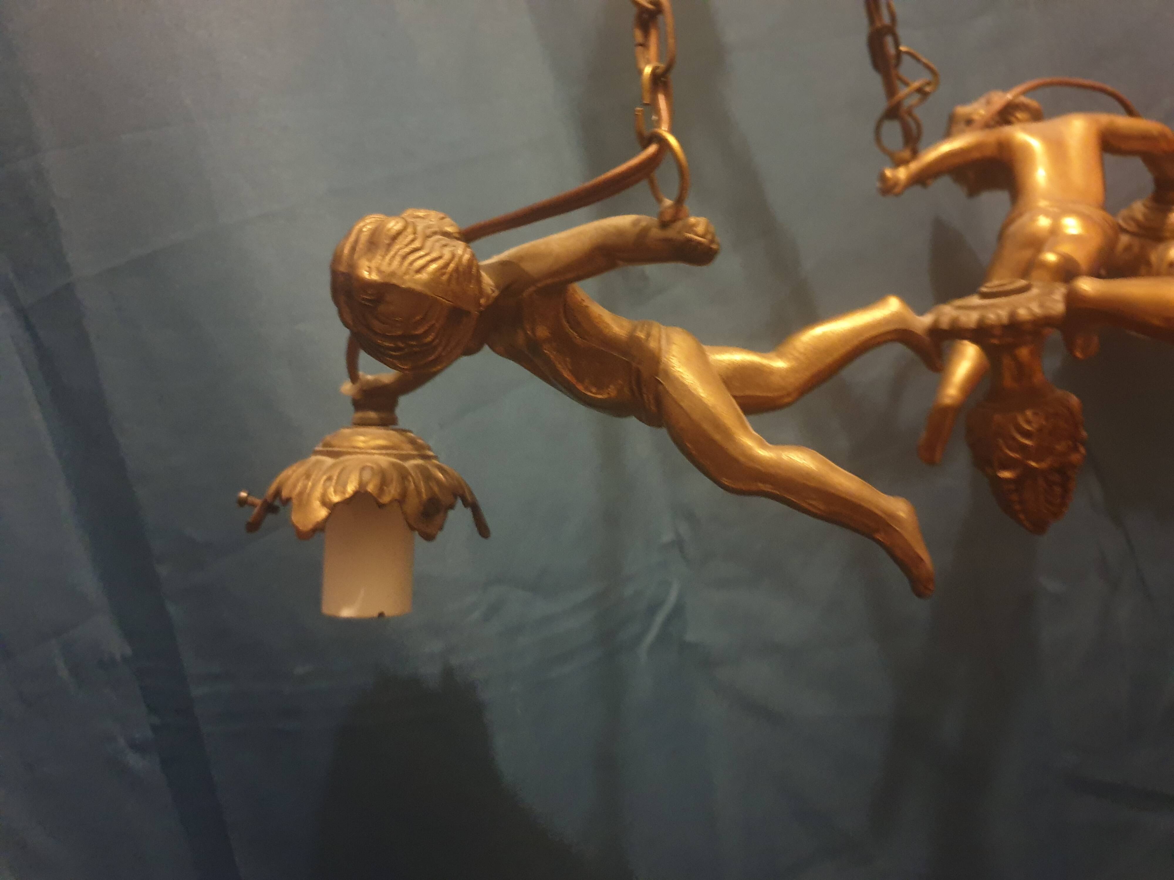 Antique chandelier decorated with cherubs and putti angels taken from the attic