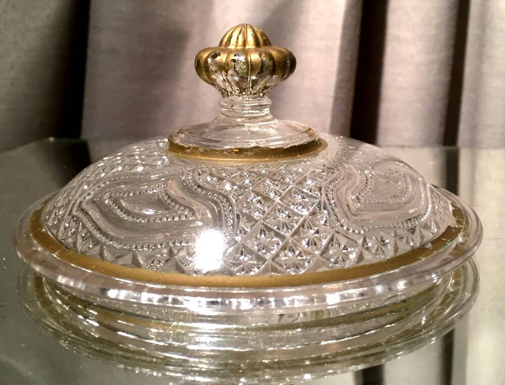 Butter dish or candy dish in pressed glass molded with golden rim