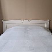 Large antique white wooden headboard, 190 cm wide.