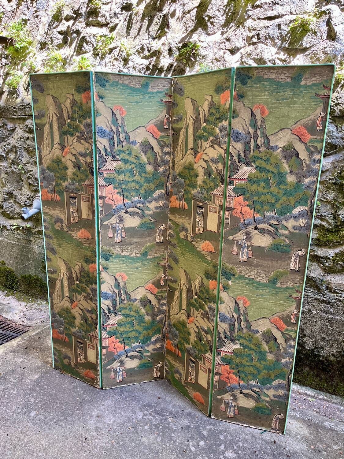 Wooden screen in Asian style, covered with Chinese wallpaper.