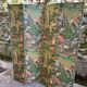 Wooden screen in Asian style, covered with Chinese wallpaper.