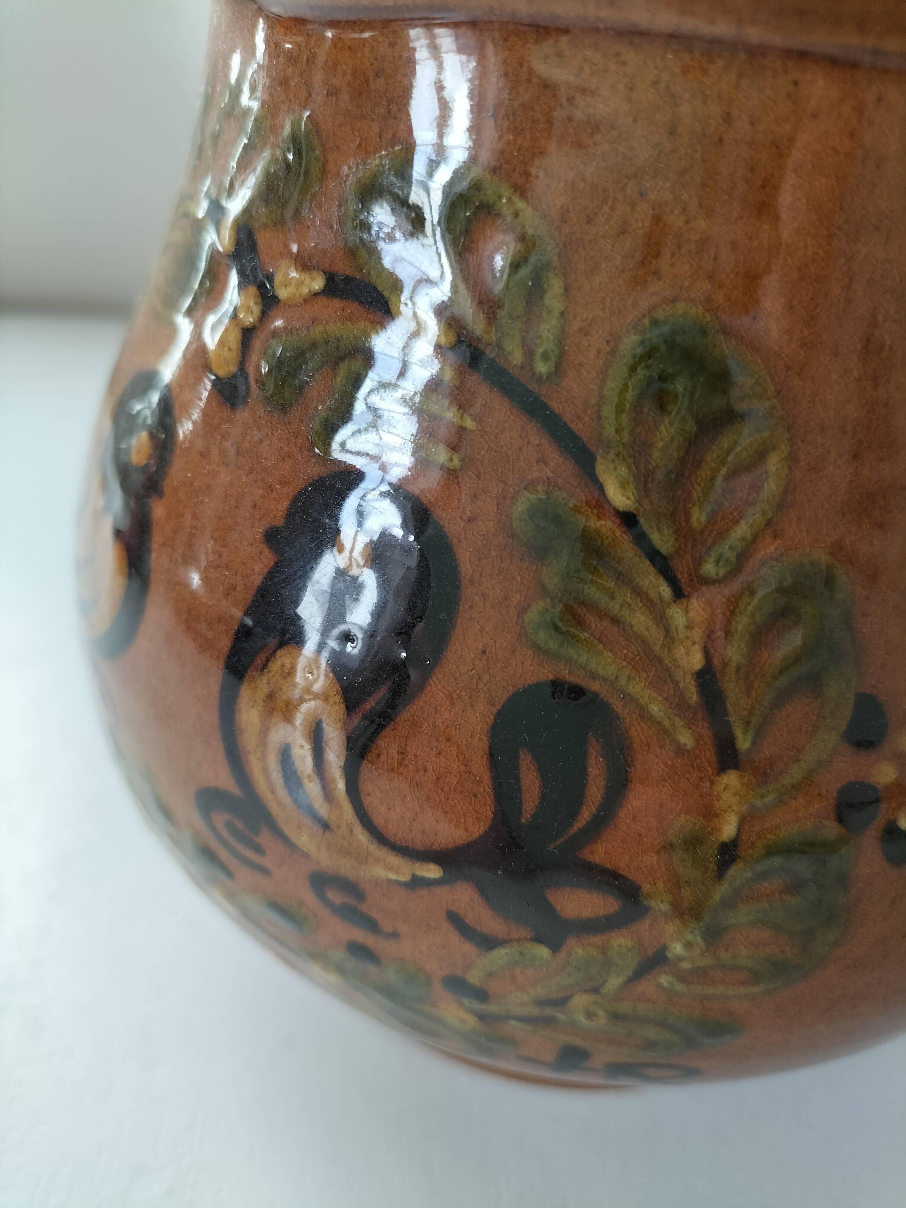 Glazed earthenware pitcher signed HR with a design of stylised birds.