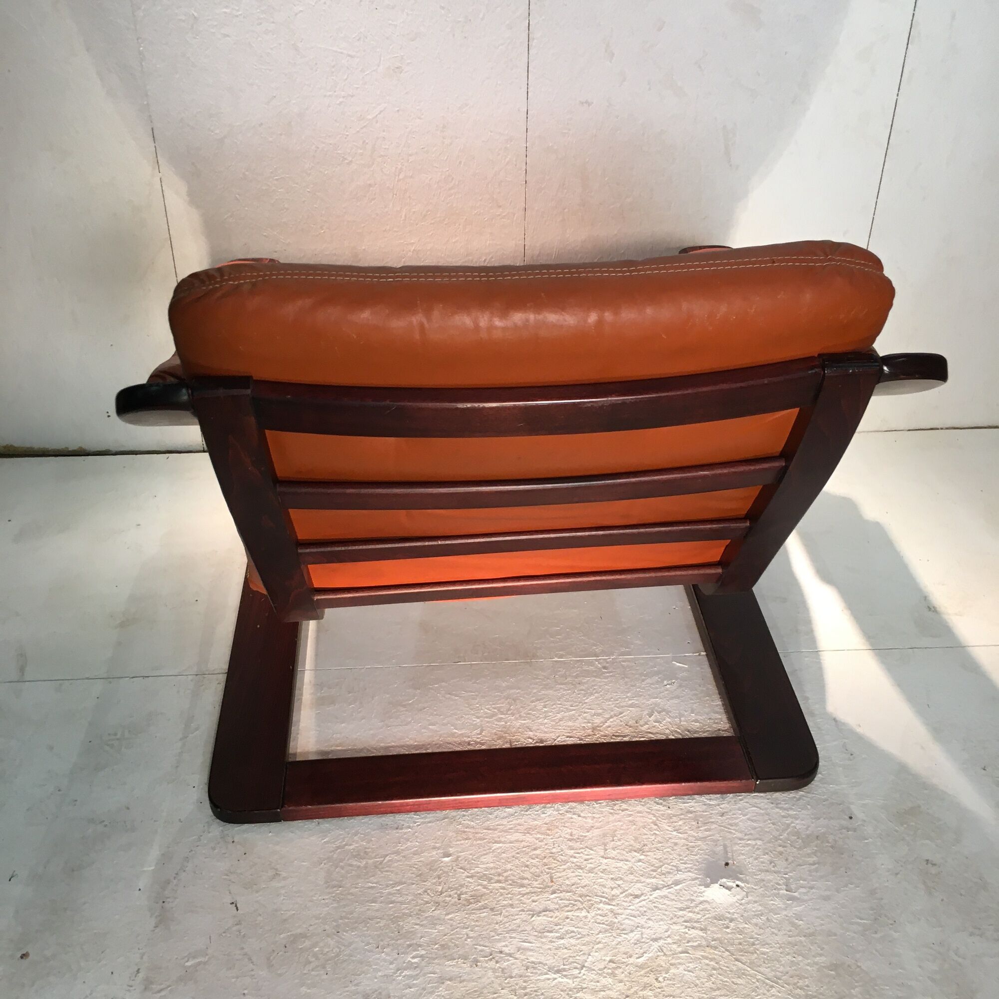 Duo of ochre leather and wood frame armchairs