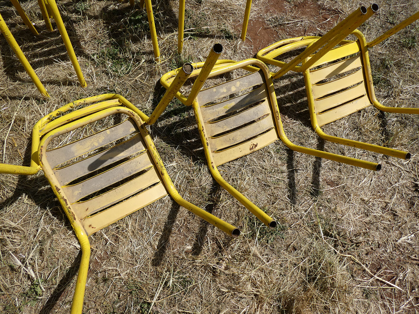 Lot of 11 yellow metallic bistro chairs from the 1950s