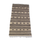 Traditional hand-woven beige and black carpet
